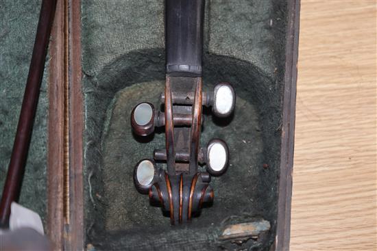 A mid 19th century German violin, bears Nicolas label, cased with a silver mounted bow, back 36cm